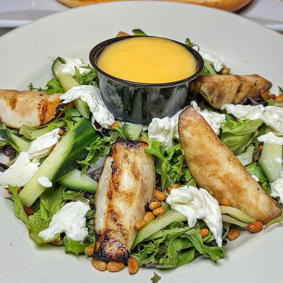 Green salad with cheese, grilled vegetables and dressing